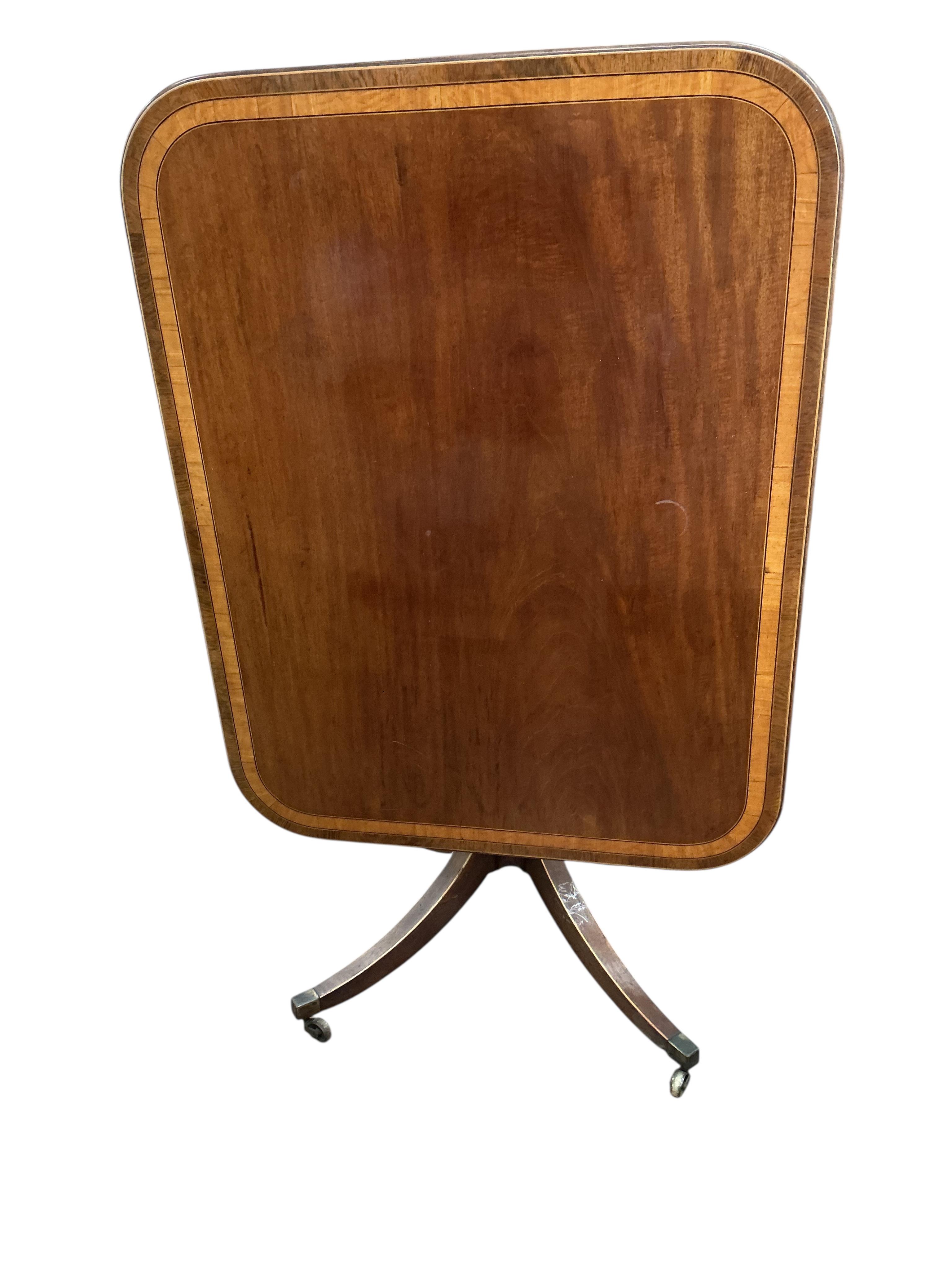 A Regency satinwood banded rectangular mahogany tilt top dining table, on four outswept legs, width 82cm, depth 104cm, height 72cm